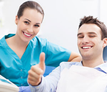 Man giving thumbs up at dentist office