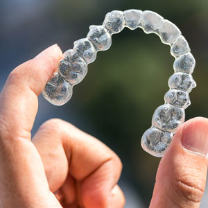 Holding invisalign braces on blur background