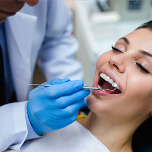Dentist examining his patient in dentist’s office