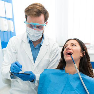 Happy smiling dentist and patient having relaxed visit at dental office