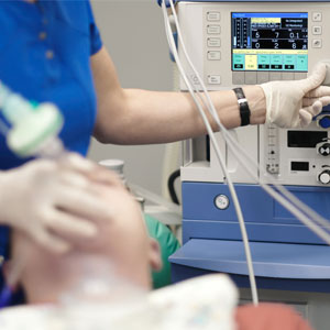 An anesthesiologist monitors the condition of a patient