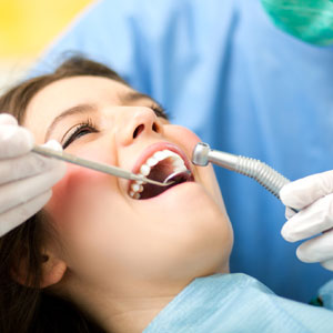 Dentist curing a female patient