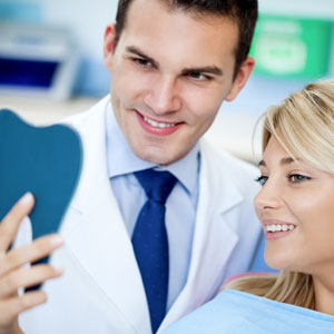 Dentist and satisfied patient with white teeth